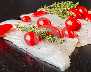 Raw sea bass fillets with cherry tomatoes