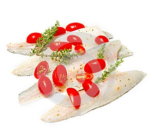 Raw sea bass fillets with cherry tomatoes on white