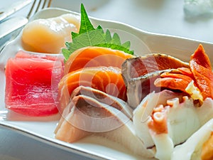 Raw seafood Japanese style, Sashimi, tuna, salmon, octopus, snapper, sea urchin, scallop, and clam, in luxury expensive restaurant