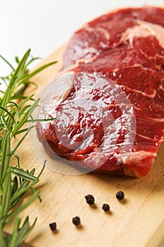 Raw seasoned beef slice on a wooden board