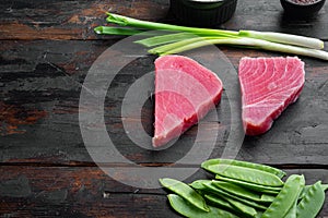 Raw sesame tuna steak ingredients, on old dark  wooden table background , with copyspace  and space for text