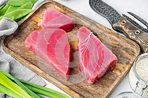 Raw sesame tuna steak ingredients, on wooden tray, on white stone  background