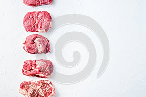 Raw set of alternative beef cuts Chuck eye roll, top blade, rump steak. Organic meat. White textured background.Top view with