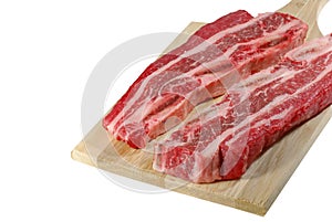 Raw short ribs on a cutting board