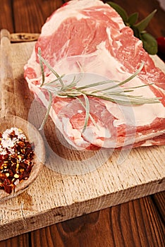 raw shoulder lamb on wooden board