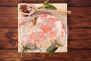 raw shoulder lamb on wooden board photo