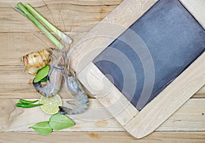 Raw shrimp with ingredient and blackboard