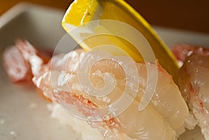 Raw Shrimp sushi with a lemon