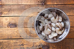 Raw Shrimp With Tails On Ready For Cooking In Prep Bowl On Rustic Wooden Table. Selective Focus. Top View With Copy Space.