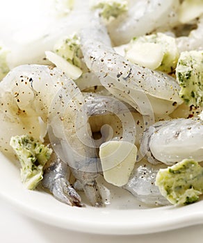 Raw shrimps marinated with garlic butter on a plate