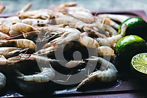 Raw shrimps on a wooden board