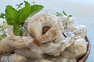 Raw shrimps in wooden plate.