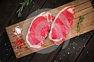 Raw sirloin beef steak on board