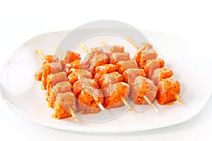 Raw skewered marinated chicken