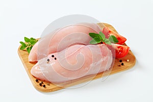 Raw skinless chicken breast fillets