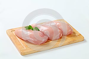 Raw skinless chicken breast fillets photo