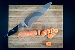 Raw sliced carrot on the wooden board