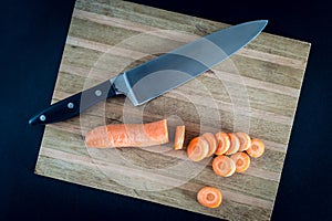 Raw sliced carrot on the wooden board