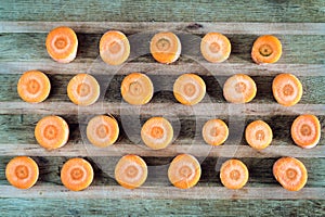 Raw sliced carrot on the wooden board