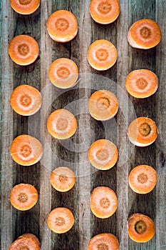Raw sliced carrot on the wooden board