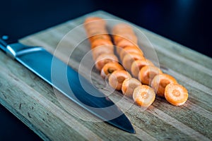 Raw sliced carrot on the wooden board