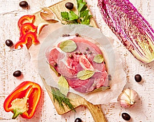 Raw slices meat with spices and herbs