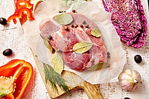 Raw slices meat with spices and herbs