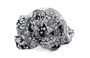 Raw snowflake obsidian stones on white background photo