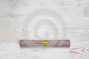 Raw soba noodle on white wooden table. Traditional Japanese food. Top view