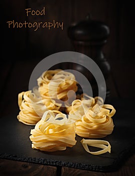 Raw spaghetti before cooking. dark background