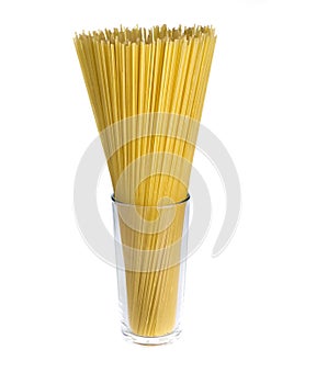 Raw spaghetti in a glass isolated on white background