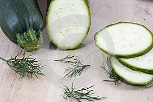 Raw squash in pieces with fennel on the wooden background