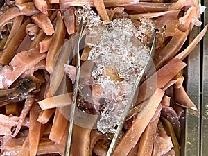 raw squid with spices and herbs in the pan