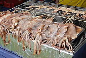 The raw squids are pecked with skewers