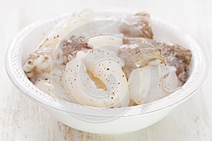 Raw squids in white plate