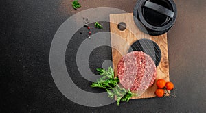 Raw steak cutlets from minced beef meat on a wooden board, Long banner format. top view