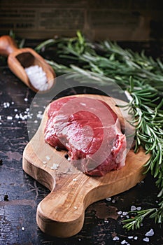 Raw steak with herbs and pepper