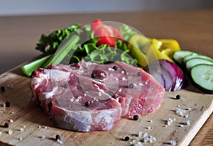 Raw steak with vegetables ready to be cooked