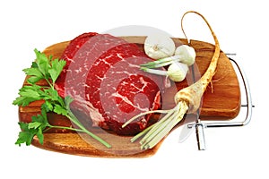 Raw steak on wooden board