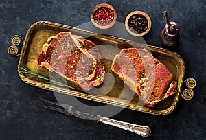 Raw steaks ribeye in marinade herbs