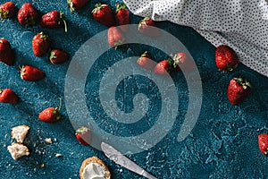 Raw strawberries on blue table