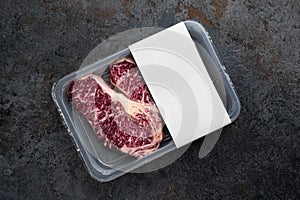 Raw Striploin marbled beef steak in vacuum packaging