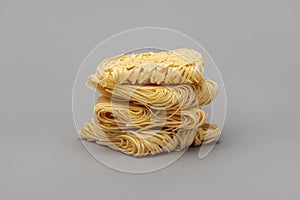 Raw strips of egg noodles on gray background