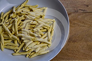 Raw strozzapreti, specialties from northern Italy, fresh twisted pasta that cooks very quickly and is suitable for chunky sauces