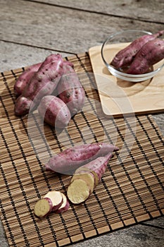 Raw sweet potato on wooden table