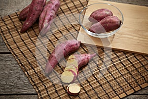 Raw sweet potato on wooden table