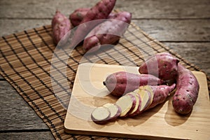 Raw sweet potato on wooden table