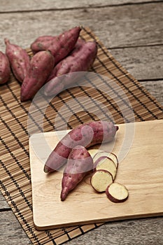 Raw sweet potato on wooden table