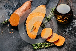 Raw sweet potatoes or batatas on wooden background. Food recipe background. Close up