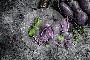 Raw sweet potatoes on dark background, Organic purple sweet potato. Raw sweet potatoes or batatas. pomoea batatas. Batata potato,